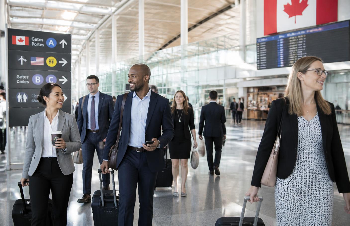 Business travellers walking through a bright Canadian airport terminal
